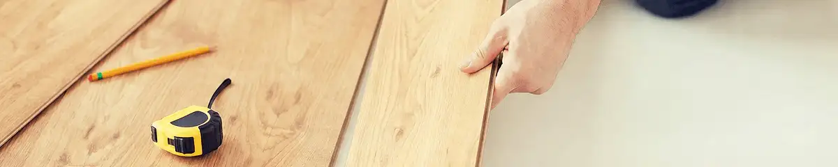 A professional installing wood flooring in Lowell, MA