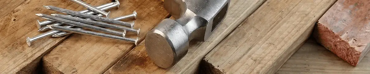 Hammer and nails on hardwood flooring boards in Lowell, MA