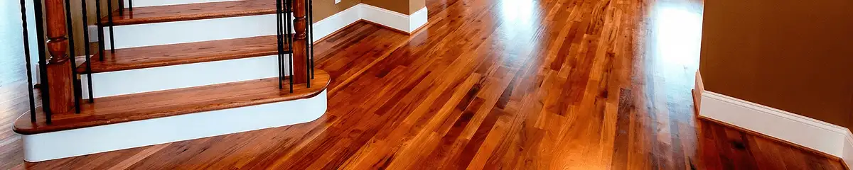 Base floor of a staircase with professionally restored wood flooring in Lowell MA