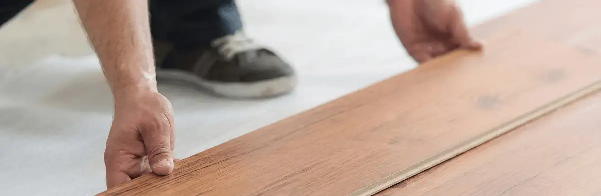 A professional installing laminate flooring in Lowell, MA