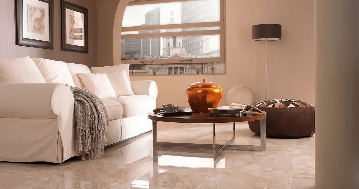 Modern living room with professionally installed marble flooring, a beige sofa, coffee table in Lowell, MA