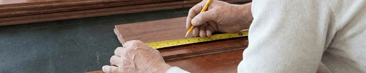 A professional installing wood flooring in Lowell, MA